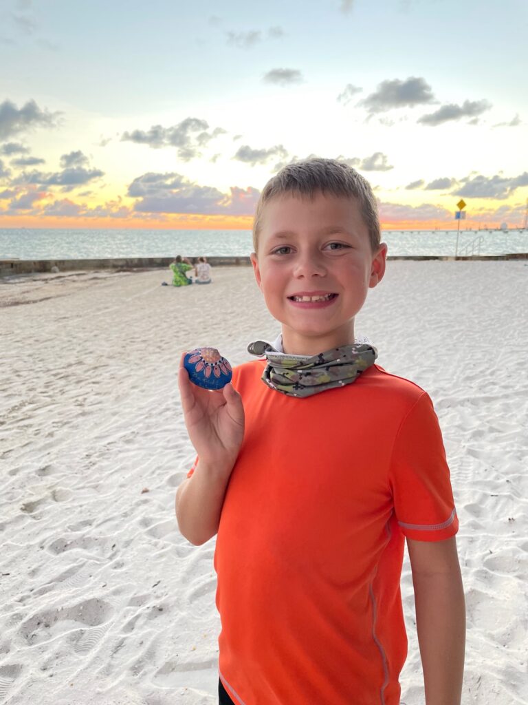 Holding a kindness rock (shell) in Key West, FL