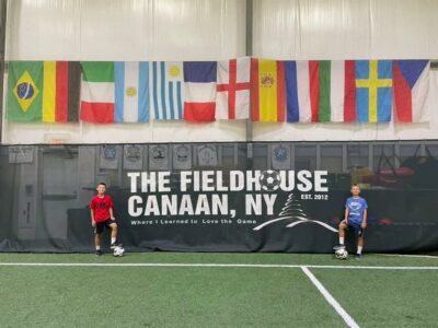 Posed picture with Canaan fieldhouse sign