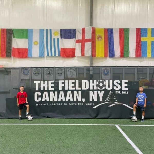 Posed picture with Canaan fieldhouse sign