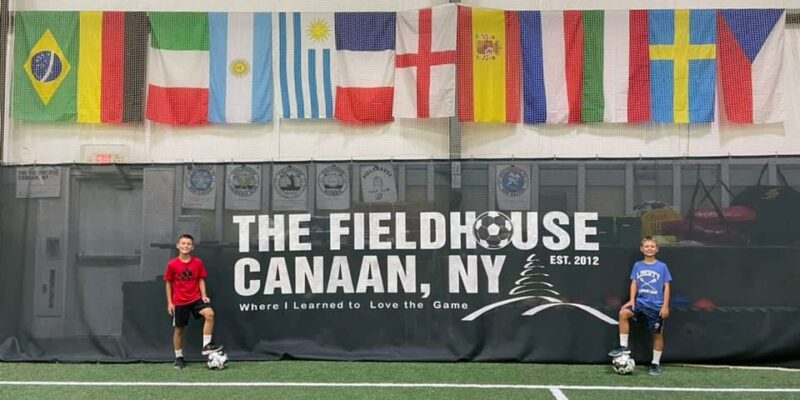 Posed picture with Canaan fieldhouse sign