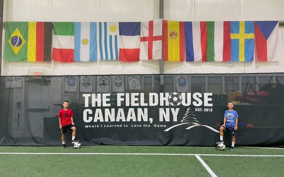 Posed picture with Canaan fieldhouse sign