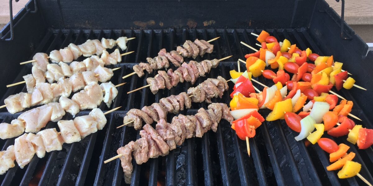 Chicken, steak, peppers on the grill for kabobs