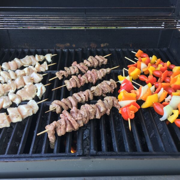 Chicken, steak, peppers on the grill for kabobs