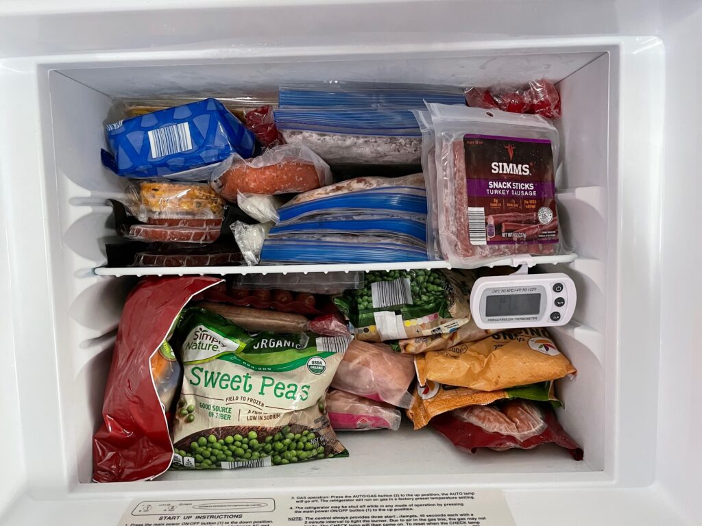 RV freezer packed with frozen foods, camper recipes, prep items for long trip